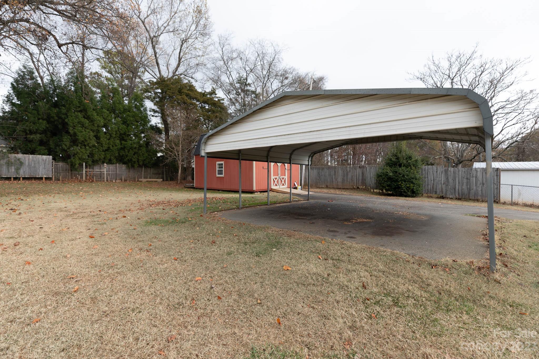 7869 Cherry Point Drive Denver, NC 28037 - Photo 30 of 38 a backyard of a house with a large tree