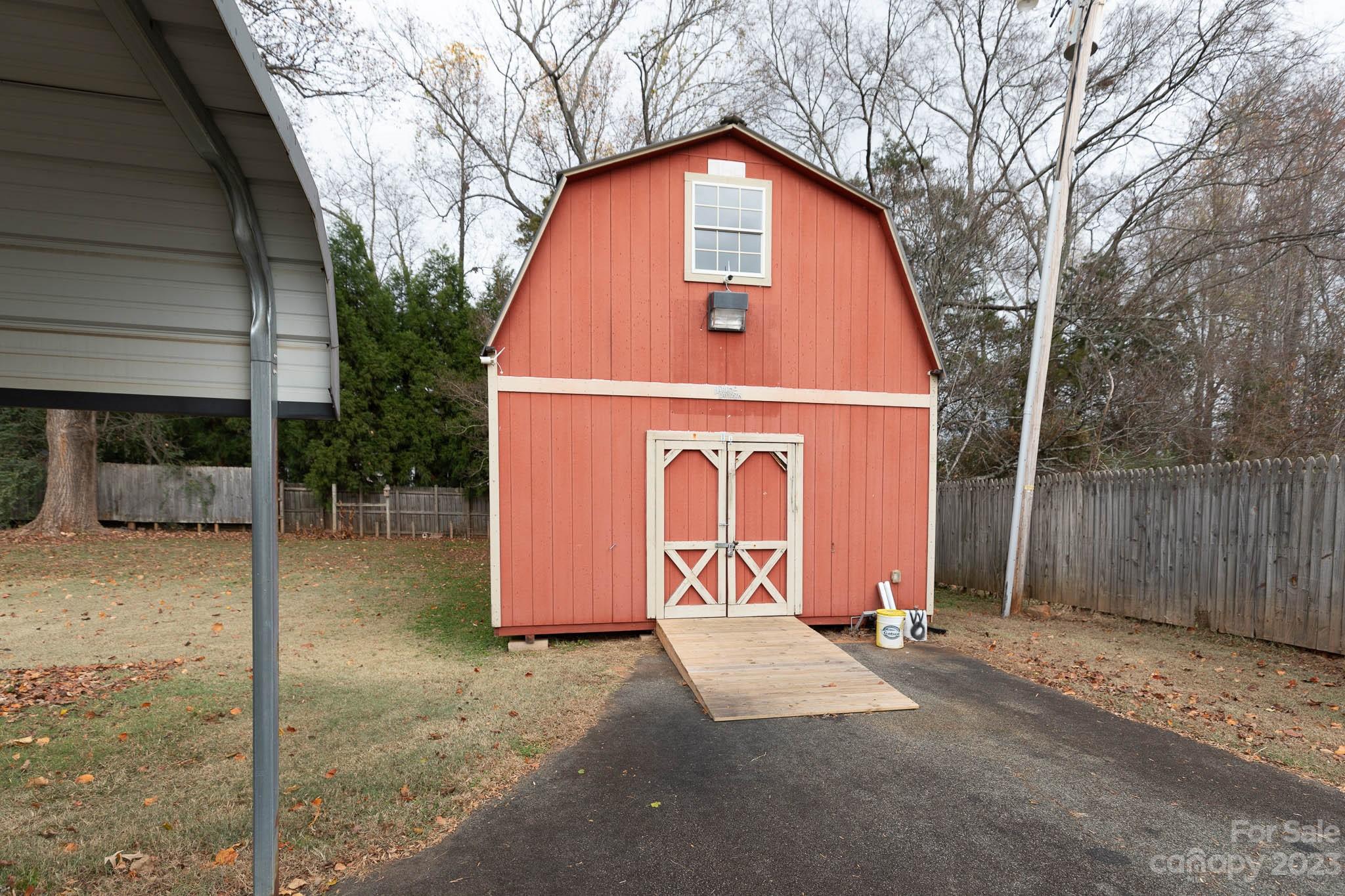 7869 Cherry Point Drive Denver, NC 28037 - Photo 31 of 38 a front view of a house with a yard garage and tree