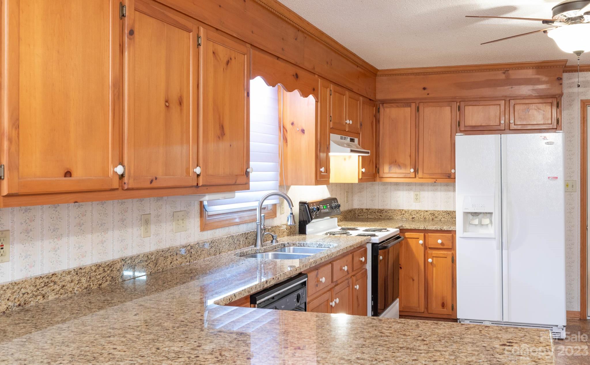 7869 Cherry Point Drive Denver, NC 28037 - Photo 4 of 38 a kitchen with stainless steel appliances granite countertop a sink a stove and a refrigerator with wooden floor