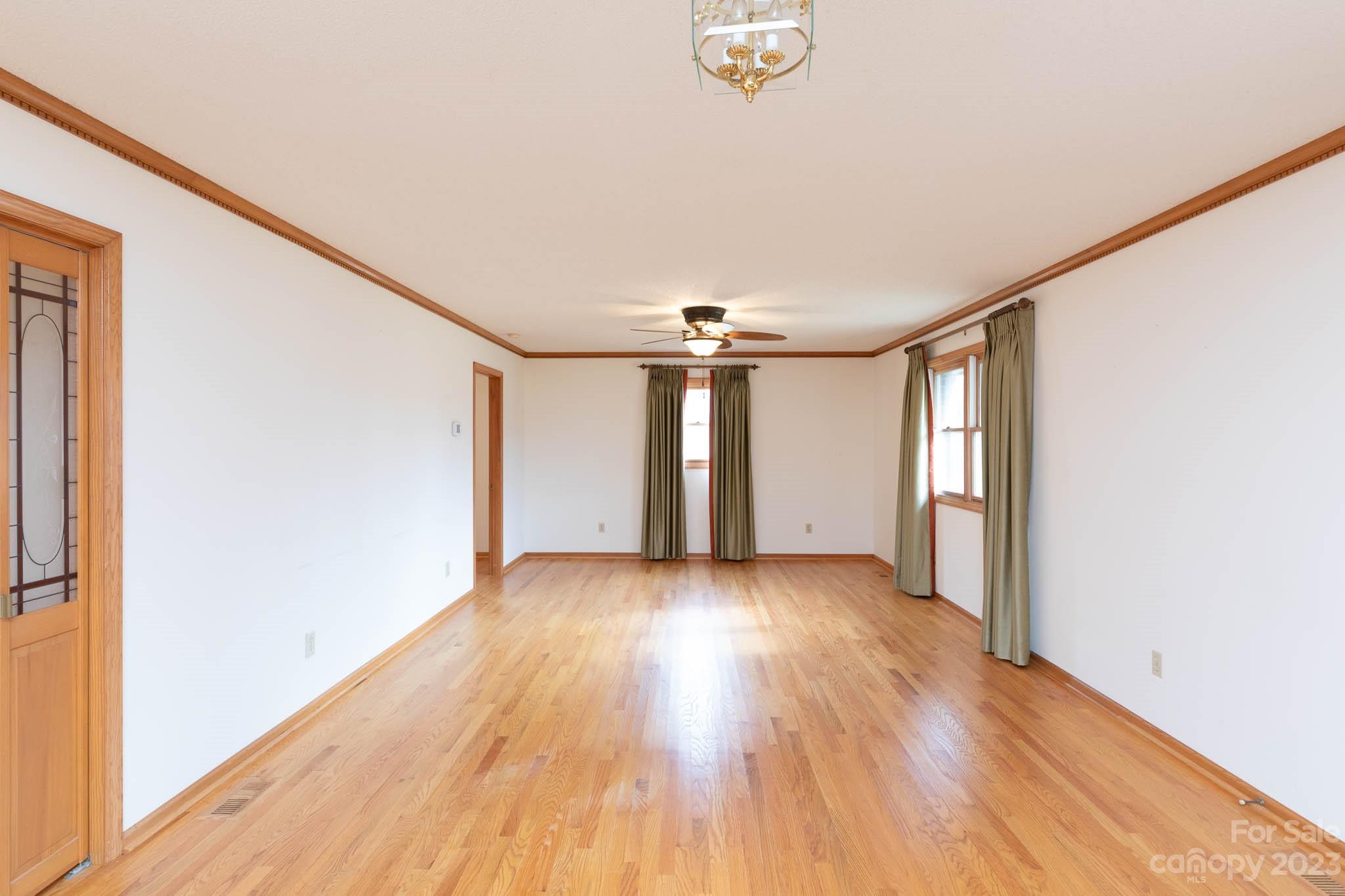 7869 Cherry Point Drive Denver, NC 28037 - Photo 8 of 38 an empty room with wooden floor and windows