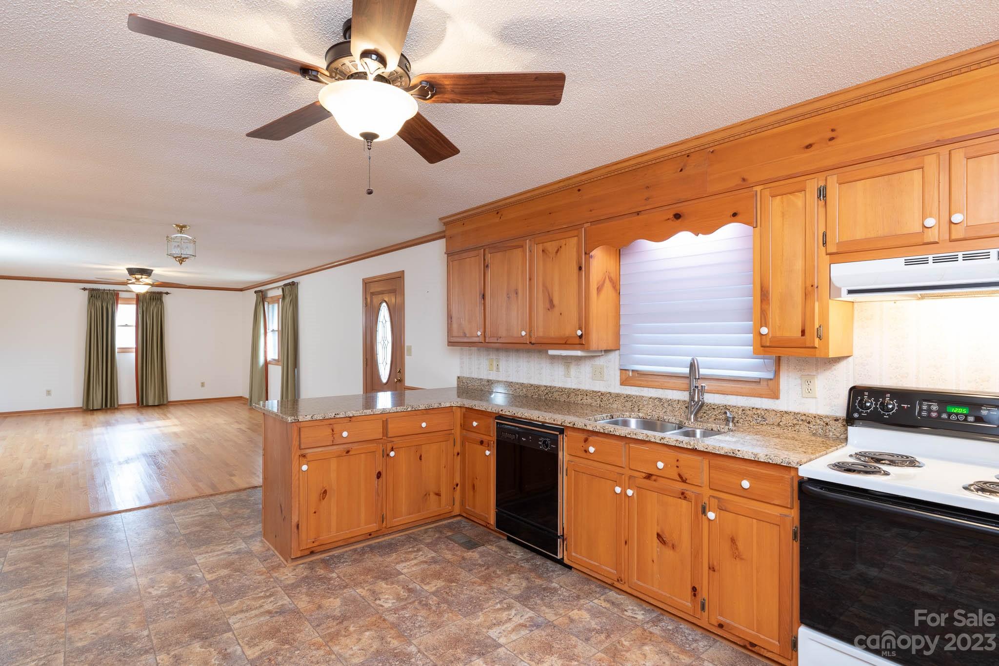 7869 Cherry Point Drive Denver, NC 28037 - Photo 10 of 38 a large kitchen with stainless steel appliances granite countertop a sink and dishwasher a stove with wooden floor