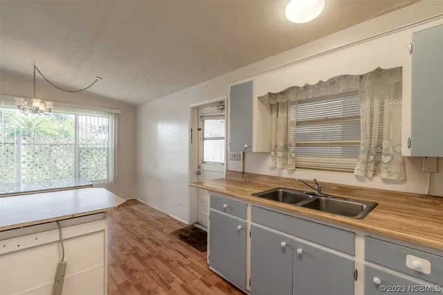 a kitchen with a sink a counter top space and cabinets