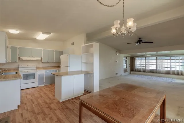 a view of a kitchen with a sink dishwasher stove and refrigerator