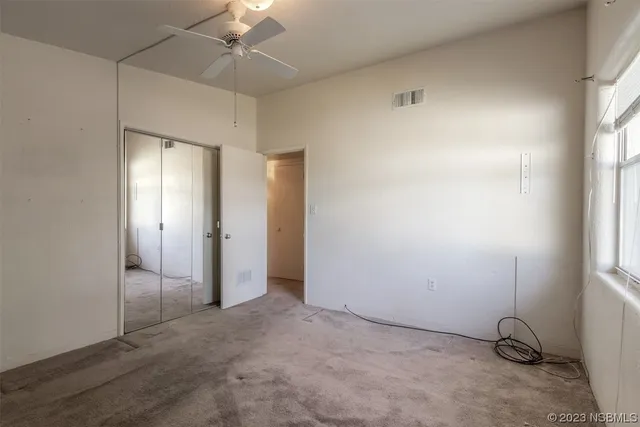 an empty room with a empty space and windows
