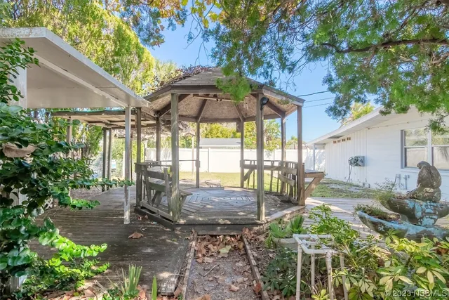 a view of a backyard with furniture and backyard