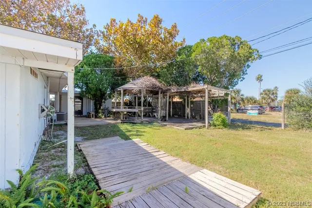 a front view of house with a garden