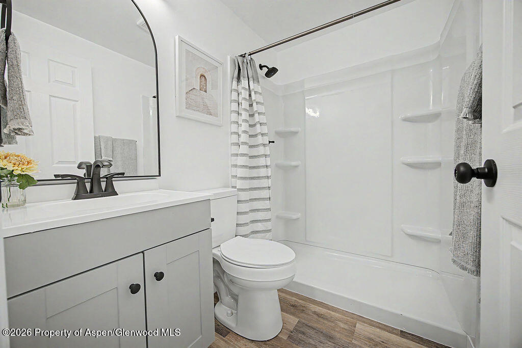 54 South Ranney Street Craig, CO 81625 - Photo 18 of 32 a bathroom with a sink a toilet and shower