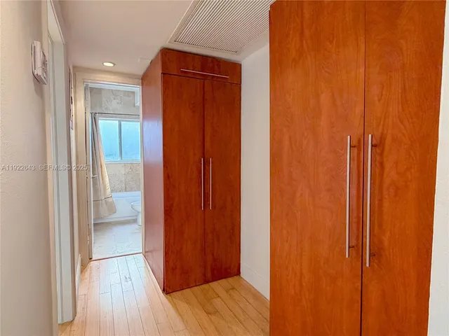 a view of a bathroom with storage and utility room