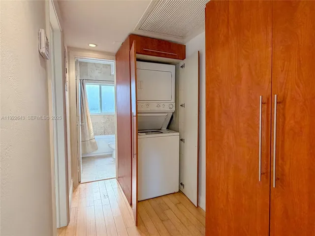 a view of a hallway with washer and dryer