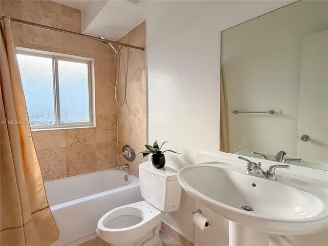 a white toilet sitting next to a bathroom sink