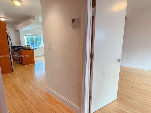 a view of a living room hardwood floor and a window
