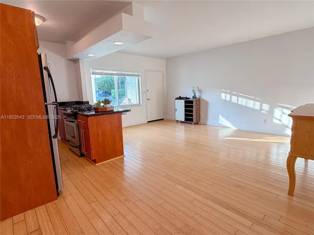 an empty room with wooden floor and furniture