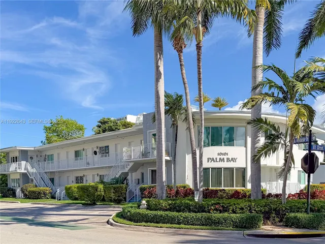 a view of multiple house with palm trees