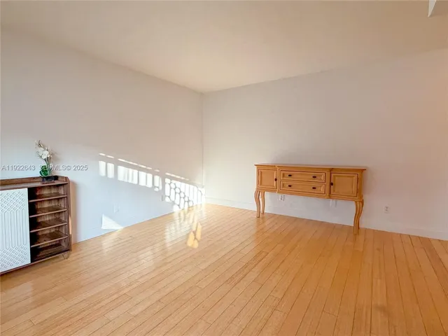 a view of a kitchen with a refrigerator cabinets and a wooden floor