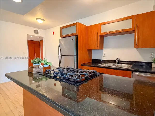 a bed sitting in a bedroom next to a cabinet and rug