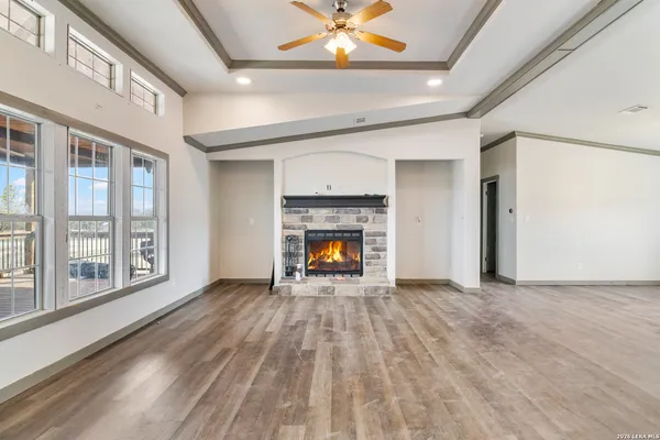 a view of an empty room with a fireplace and a window