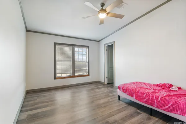a bedroom with a large bed and a chandelier