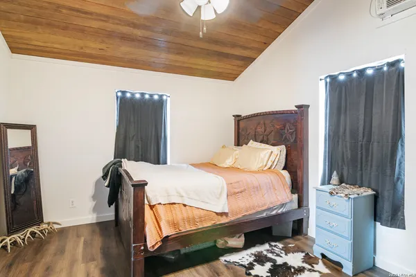 a bedroom with a bed and a dresser