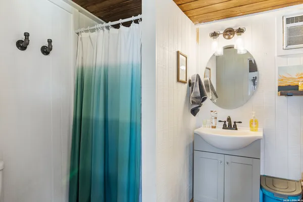 a bathroom with a sink vanity and a mirror