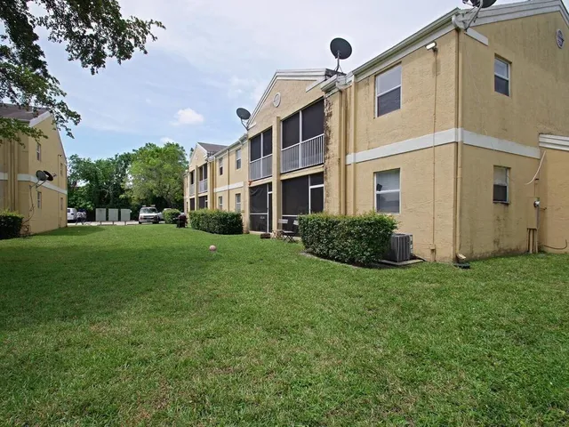 a view of a building with a yard