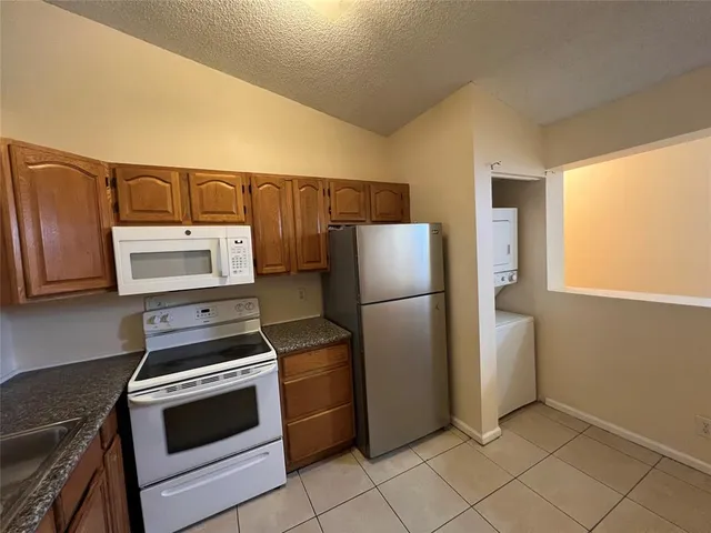 a kitchen with a refrigerator stove and microwave