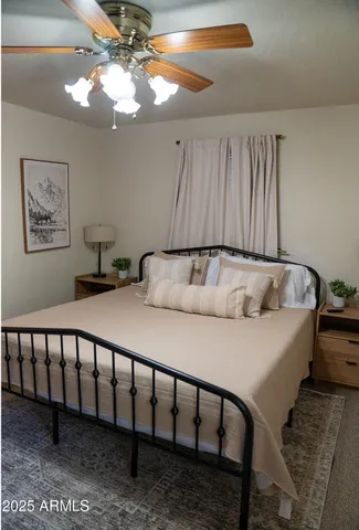 a bed sitting in a bedroom next to a window