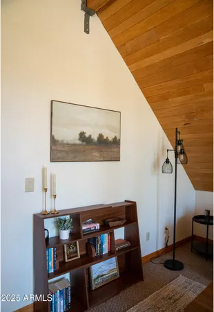a living room with baby crib and a wooden floor