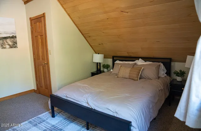 a bed sitting in a bedroom next to a small yard