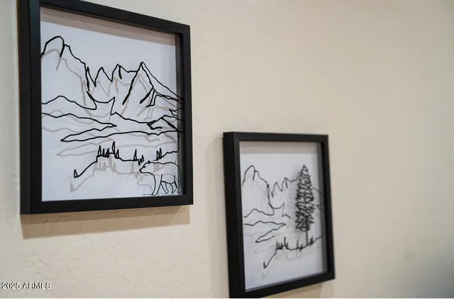 a white wall with a painting on the wall