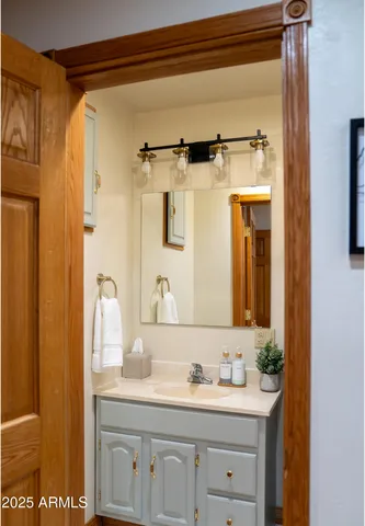 a bathroom with a granite countertop sink a mirror and a shower