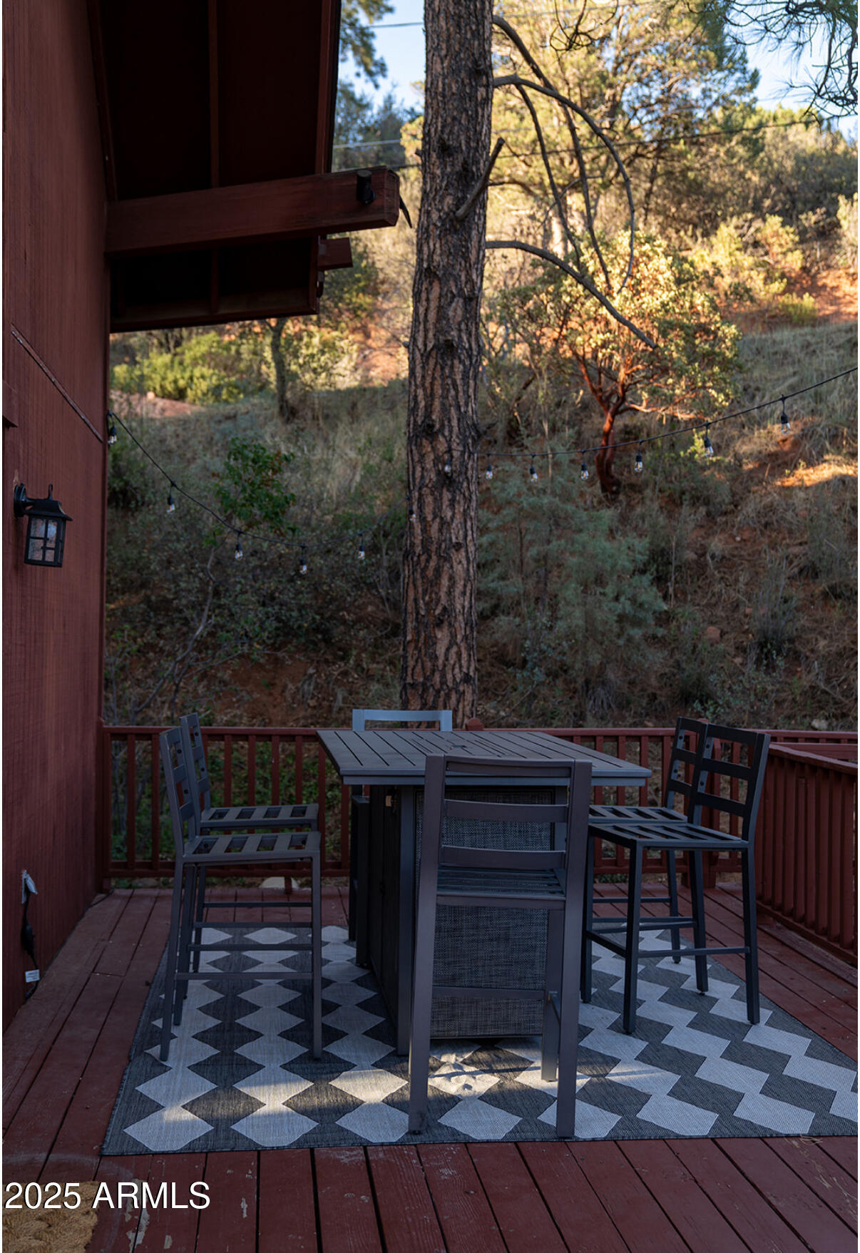 9651 Wild Turkey Lane Strawberry, AZ 85544 - Photo 40 of 41 a view of a patio with table and chairs with wooden floor and fence