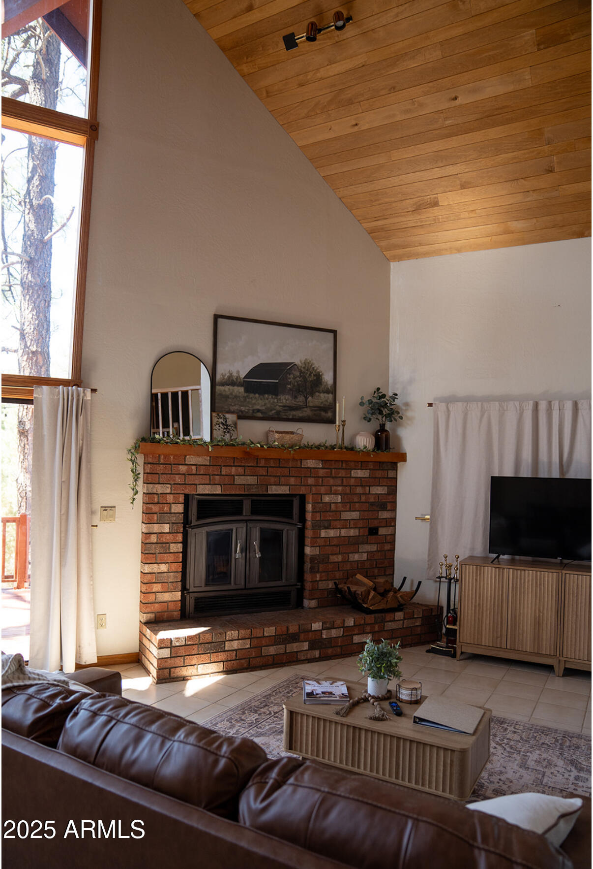9651 Wild Turkey Lane Strawberry, AZ 85544 - Photo 6 of 41 a living room with furniture a flat screen tv and a fireplace