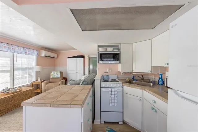 a kitchen with sink a stove and cabinets