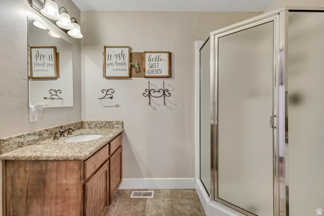 3054 West Ridgeline Road Stockton, UT 84071 - Photo 48 of 88 Full bath with vanity, a shower stall, and light tile patterned flooring