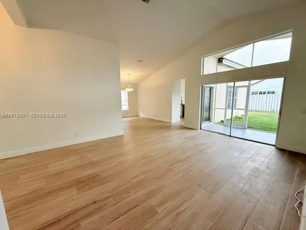 a view of an empty room with a window