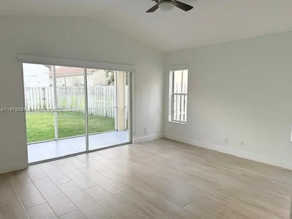 an empty room with sliding glass door