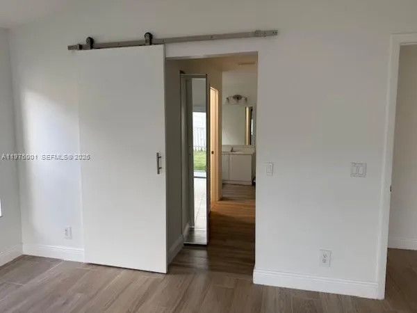 a view of a hallway with wooden floor