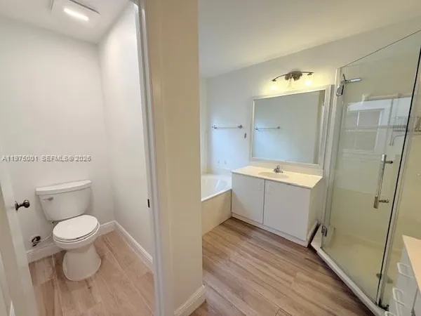 a bathroom with a sink toilet a mirror and shower