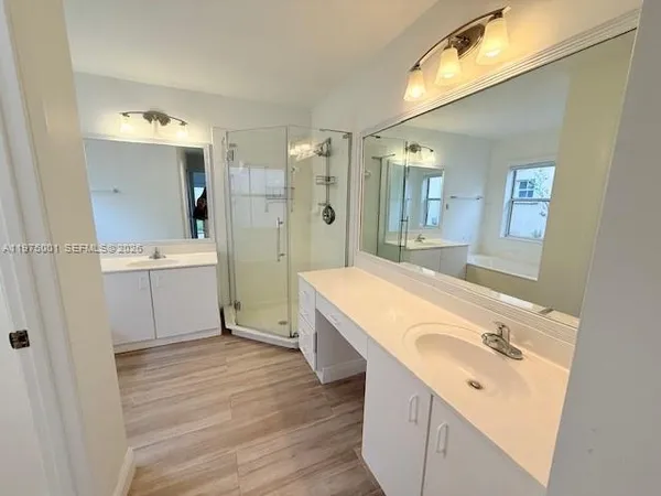 a bathroom with a sink a mirror and a shower