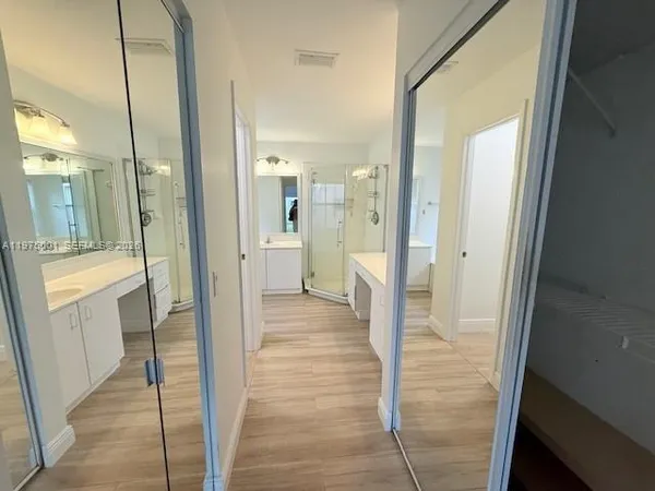a bathroom with a shower and a sink