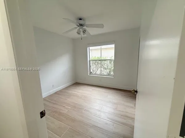 an empty room with windows and closet