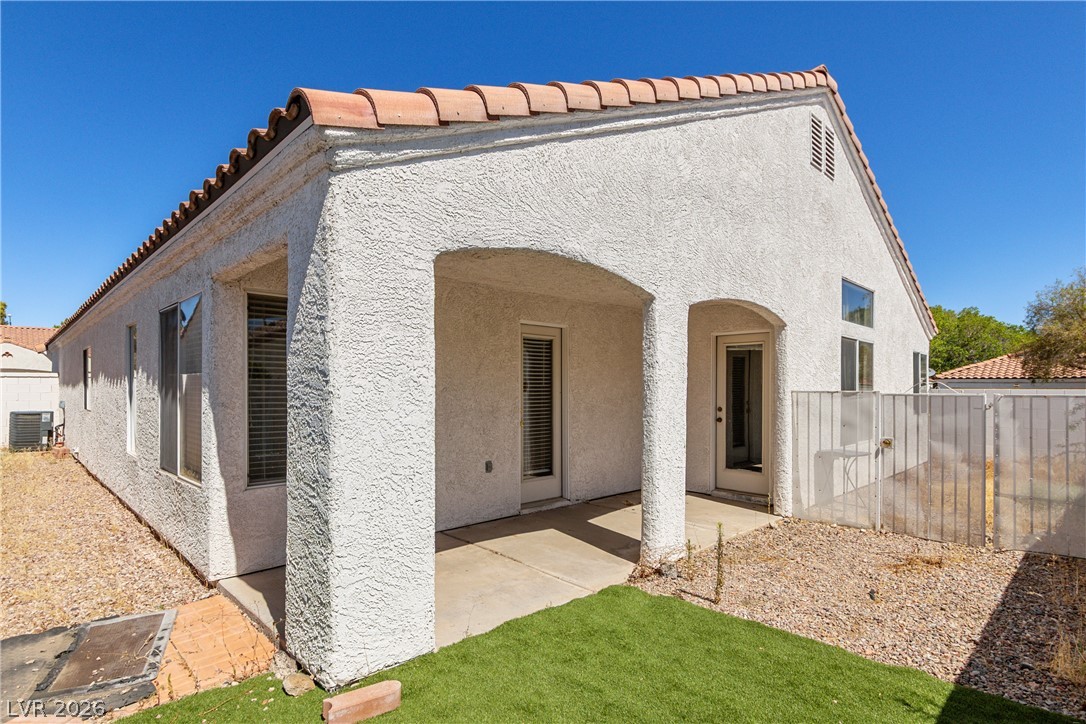 1815 Stablegate Avenue Henderson, NV 89012 - Photo 23 of 28 A covered patio retreat complements this Mediterranean-style home with a terra cotta tile roof.