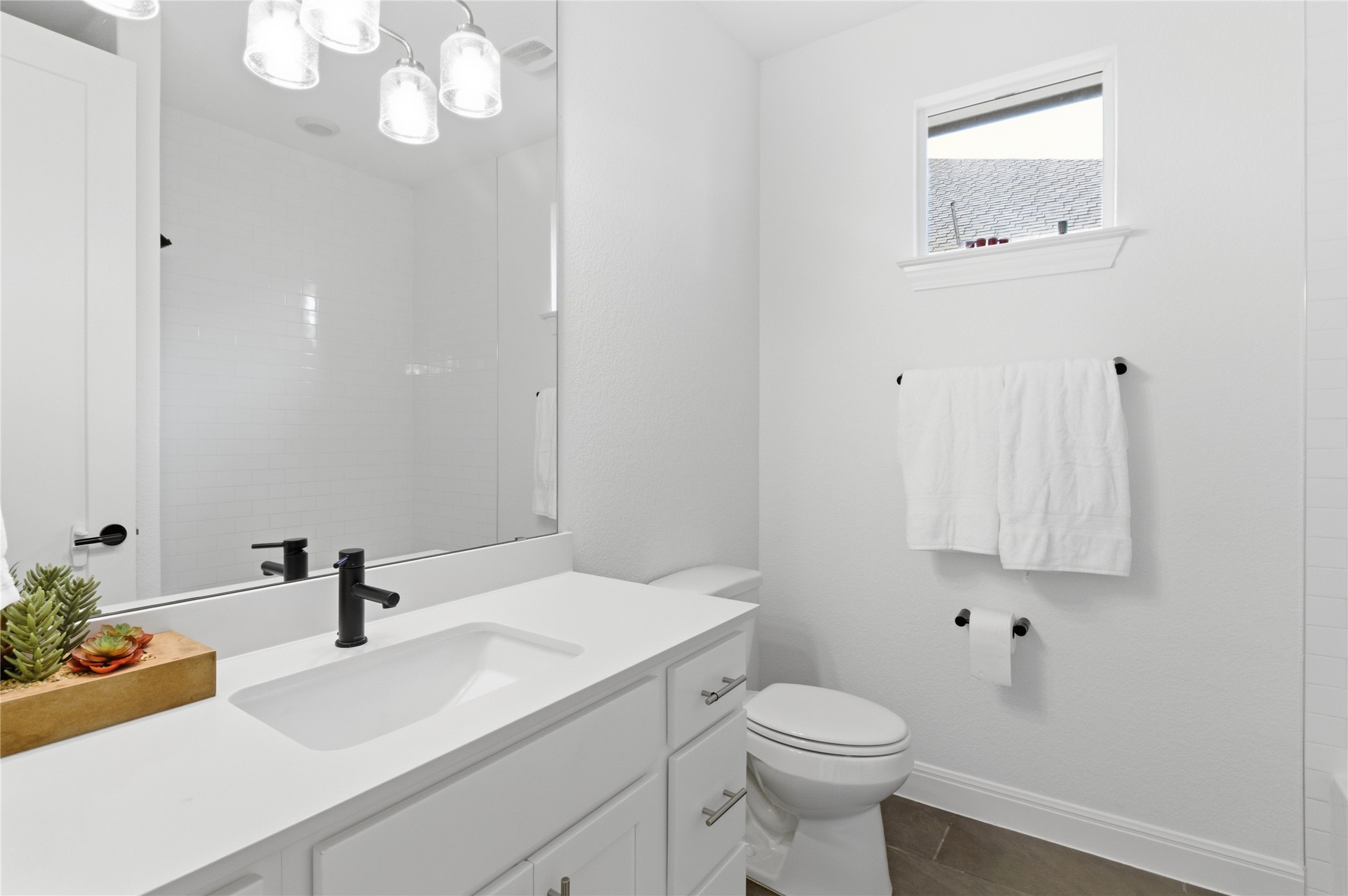 2032 Rushing Ranch Path Georgetown, TX 78628 - Photo 21 of 30 Crisp white walls and clean stone counters define this modern bathroom.