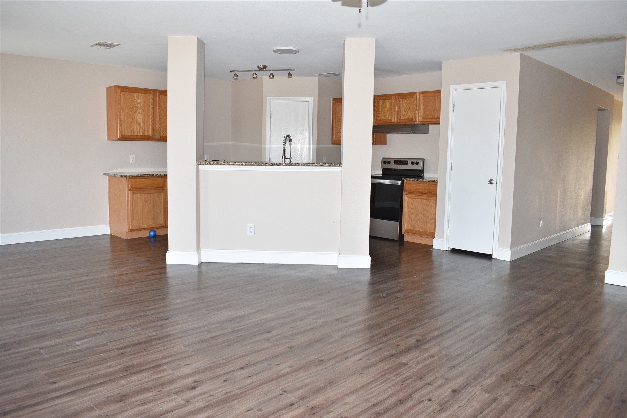 804 Lavaca Loop Elgin, TX 78621 - Photo 4 of 11 Kitchen with stainless steel appliances open to dining and living areas