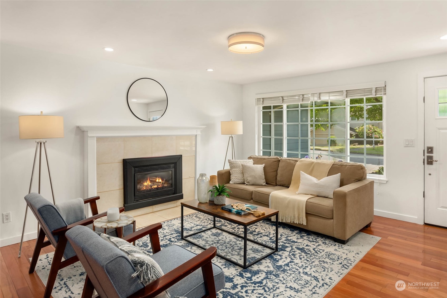 4200 Northeast 19th Street Renton, WA 98059 - Photo 14 of 25 a living room with furniture a rug a fireplace and a window