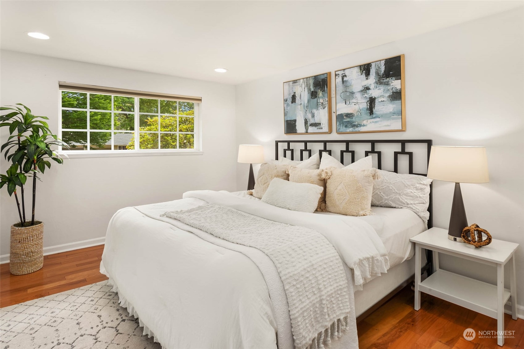 4200 Northeast 19th Street Renton, WA 98059 - Photo 16 of 25 a bedroom with a bed and a potted plant