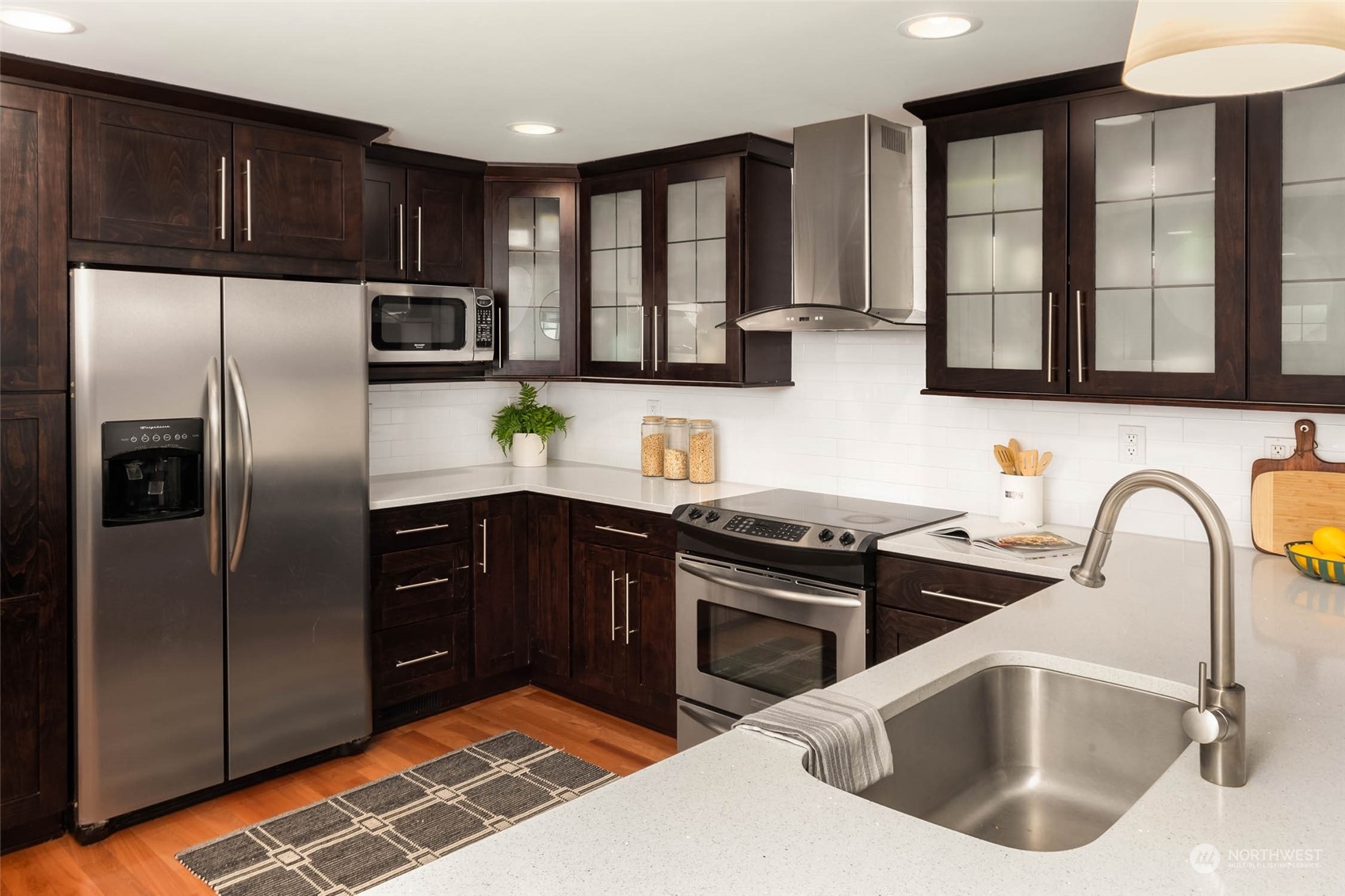 4200 Northeast 19th Street Renton, WA 98059 - Photo 7 of 25 a kitchen with stainless steel appliances granite countertop a sink stove and refrigerator