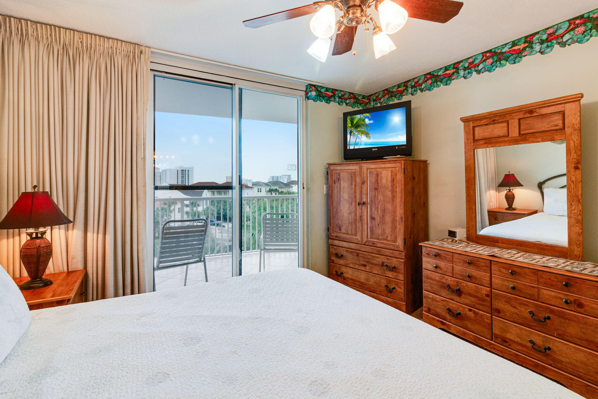 970 Highway 98, Unit 303 Destin, FL 32541 - Photo 24 of 42 a bedroom with furniture and a flat tv screen
