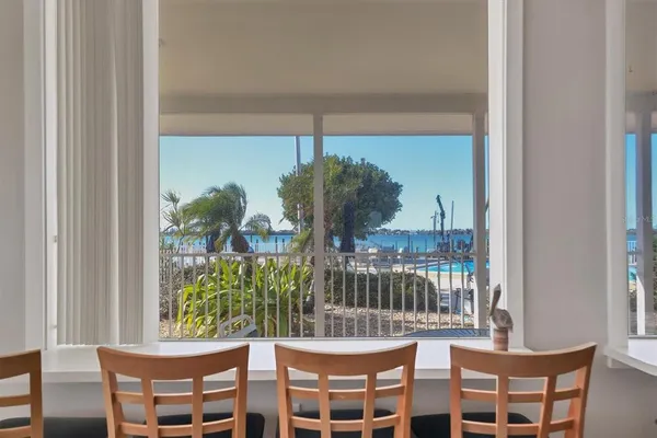 a dining room with furniture and a floor to ceiling window