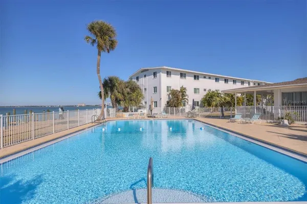 swimming pool view with a garden space